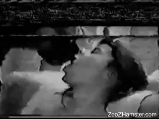 B&W retro sex tape featuring a brunette and her kinky dog