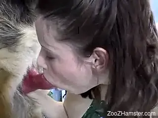 Drooling beauty deepthroating a dog's red cock