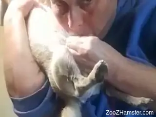 Mature stands clothed and fools around with her dog's dick