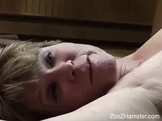 Busty woman in her late 40s fitted with dog dick on cam