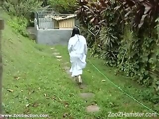 Busty Latina woman fitted with dog dick in backyard XXX