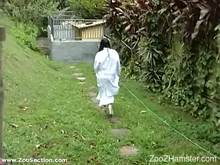 Busty Latina woman fitted with dog dick in backyard XXX
